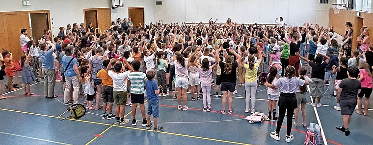Der neue Entfelder Ohrwurm nimmt Gestalt an: Bei der gemeinsamen Probe in der Turnhalle Dorf in Oberentfelden singen die Unterstufenkinder den neuen Song erstmals als grosser Chor.Bild: AGU