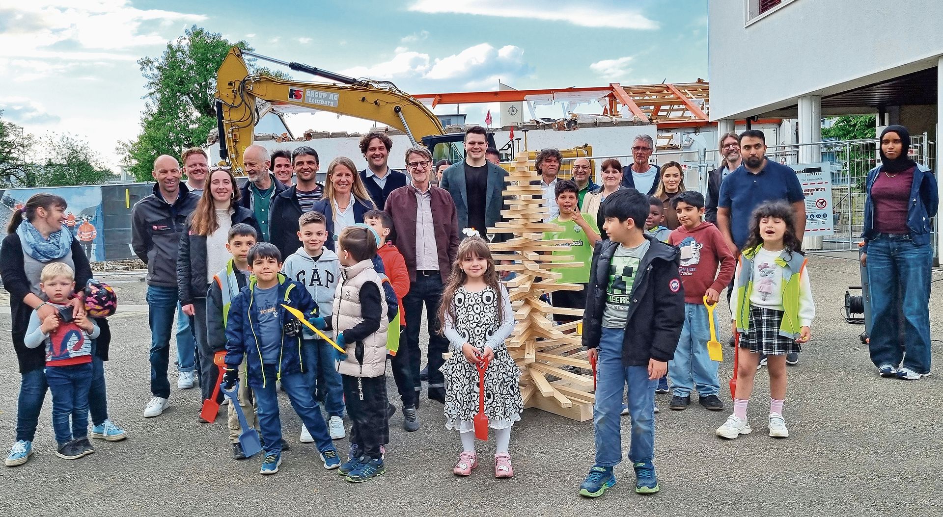 Alle Projektbeteiligten – Vertreter der Gemeinde, der Schule, der Planer und der Bauunternehmen – versammelten sich zum gemeinsamen Gruppenbild zum Auftakt der bauarbeiten des Neubaus «Donum Silvae» in Suhr. Bild: ZVG