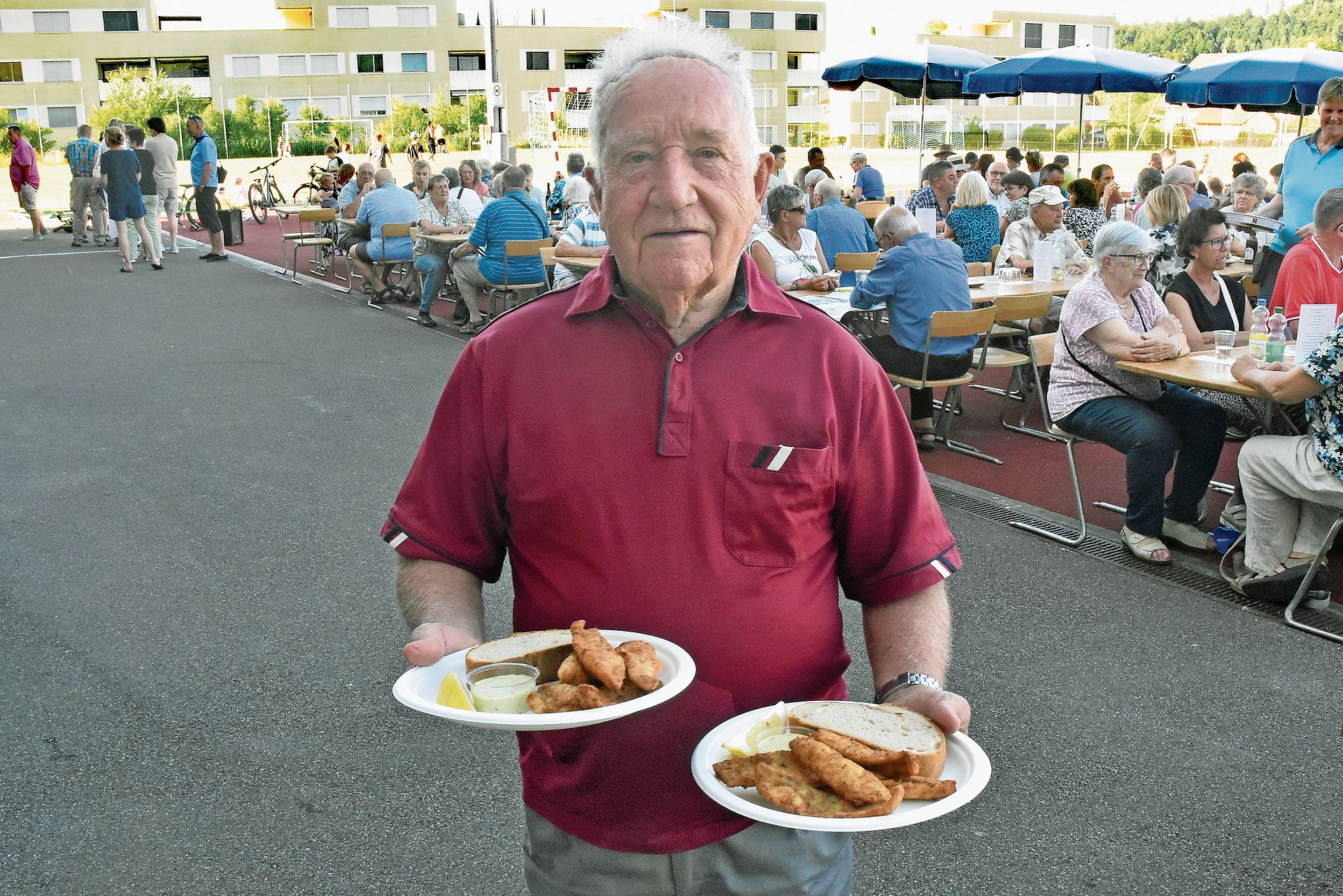 Der bekannte Staffelbacher Josef Keist bringt zwei Fischportionen zu seinem Tisch. Der bekannte Staffelbacher Josef Keist bringt zwei Fischportionen zu seinem Tisch.